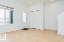 Entryway featuring light-toned flooring, a window with a blind, and a white door with decorative glass - 9652 Colak Link Link, Edmonton, AB  - Indoor Photo Showing Other Room 