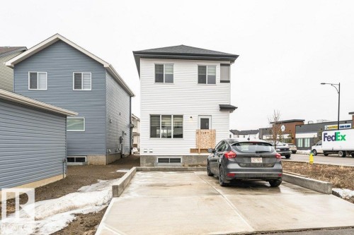 The property features a two-story exterior with white siding and a dark roof - 9652 Colak Link Link, Edmonton, AB - Outdoor