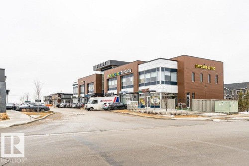 The property features a modern commercial building with brown and white exterior finishes - 9652 Colak Link Link, Edmonton, AB - Outdoor