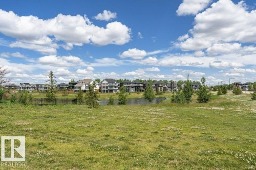 The property is located within a community featuring a pond and extensive green spaces - 9652 Colak Link Link, Edmonton, AB - Outdoor With View