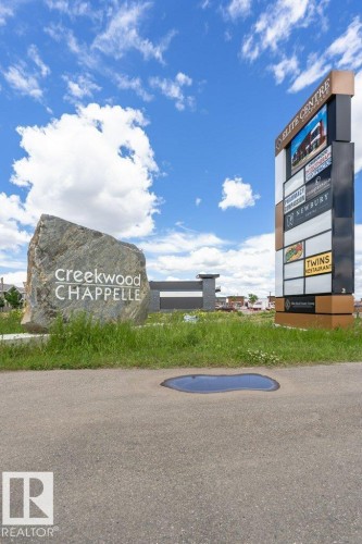 Community amenities include a large stone sign with community name and a multi-tenant commercial signage tower - 9652 Colak Link Link, Edmonton, AB - Outdoor