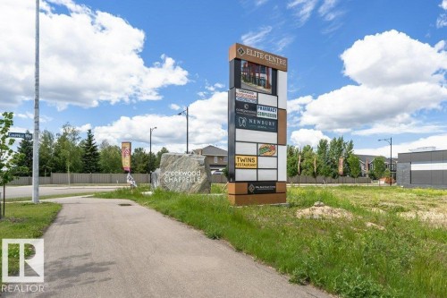 The property is located near a commercial center, featuring a prominent business sign with several establishments - 9652 Colak Link Link, Edmonton, AB - Outdoor