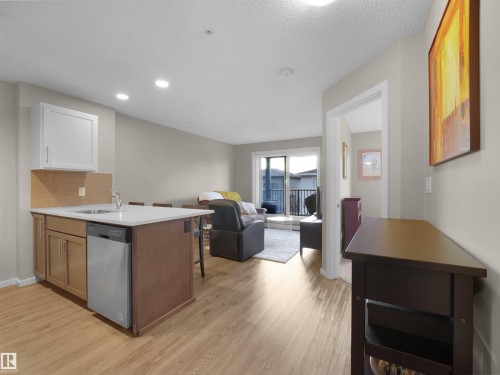 The property features an open-concept living space with light-toned flooring throughout - 214 394 Windermere Road, Edmonton, AB - Indoor