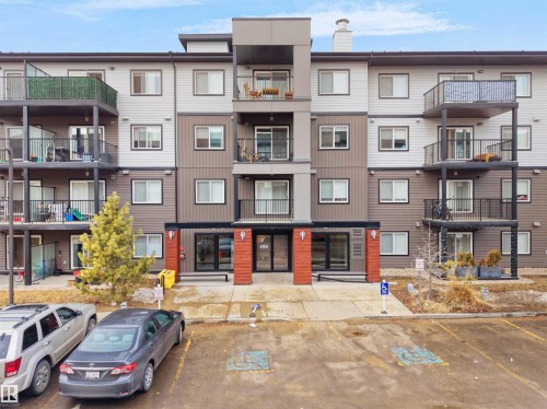The property features a multi-story building with a modern facade, including balconies with dark railings - 214 394 Windermere Road, Edmonton, AB - Outdoor With Balcony With Facade