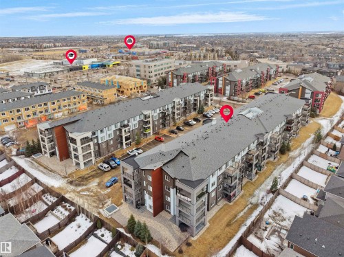 Aerial view showcasing the property's location within a developed community, featuring residential buildings and surrounding infrastructure - 214 394 Windermere Road, Edmonton, AB - Outdoor With View