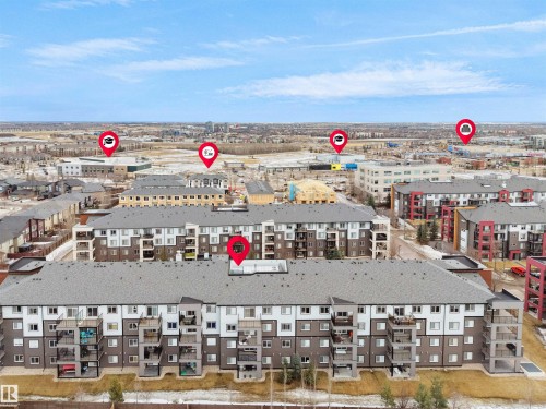 Aerial view of the condominium building featuring a grey roof and balconies - 214 394 Windermere Road, Edmonton, AB - Outdoor With View
