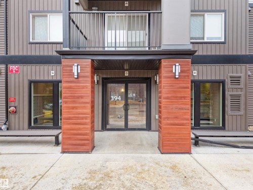 The property features a modern exterior with horizontal siding and wood-look accents - 214 394 Windermere Road, Edmonton, AB - Outdoor With Balcony