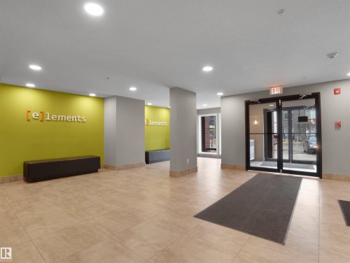 Lobby featuring tile flooring, recessed lighting, and a vibrant accent wall - 214 394 Windermere Road, Edmonton, AB - Indoor