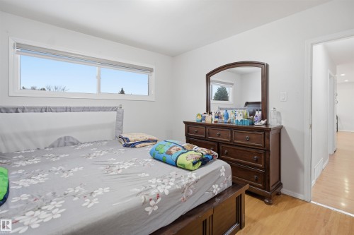 This bedroom features light-colored walls and light wood flooring, creating a bright and airy atmosphere - 16049 95 Avenue, Edmonton, AB - Indoor Photo Showing Bedroom