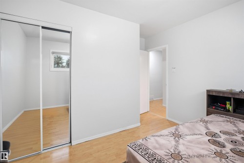 This room features light-colored flooring, white walls, and a window providing natural light - 16049 95 Avenue, Edmonton, AB - Indoor Photo Showing Bedroom