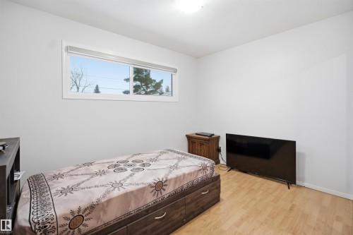 This room features light-colored walls and wood-look flooring, creating a bright and inviting atmosphere - 16049 95 Avenue, Edmonton, AB - Indoor Photo Showing Bedroom