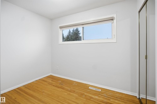 Room featuring hardwood flooring, a window providing natural light, and light-colored walls - 16049 95 Avenue, Edmonton, AB - Indoor Photo Showing Other Room