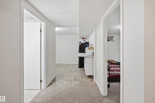 This interior space features white walls, two doorways, and a textured ceiling - 16049 95 Avenue, Edmonton, AB - Indoor