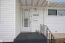 The property features white siding and a covered front entry with a white storm door - 16049 95 Avenue, Edmonton, AB  - Outdoor With Exterior 