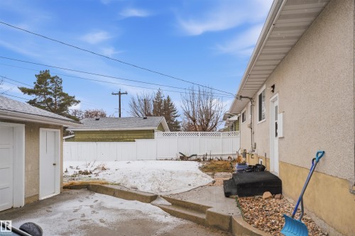 The property includes a detached garage and a paved driveway - 16049 95 Avenue, Edmonton, AB - Outdoor