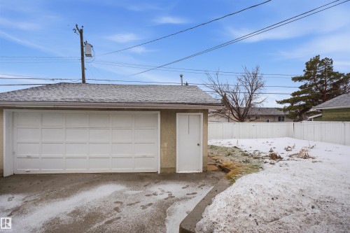 Detached garage with a single white garage door and a side entry door - 16049 95 Avenue, Edmonton, AB - Outdoor