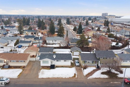 Aerial view of the property and its surrounding neighborhood, featuring a detached residence with a dark roof and light-colored siding, along with a detached garage - 16049 95 Avenue, Edmonton, AB - Outdoor With View