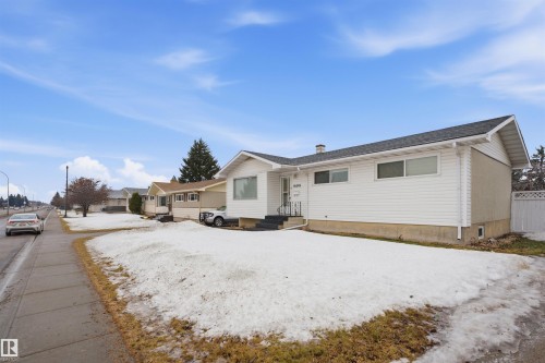 The property features white siding and a dark shingled roof - 16049 95 Avenue, Edmonton, AB - Outdoor