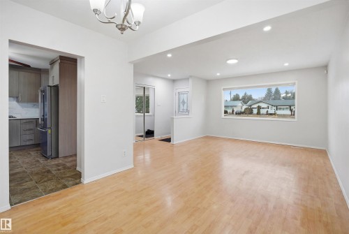 The property features light wood flooring, bright white walls, and recessed lighting - 16049 95 Avenue, Edmonton, AB - Indoor