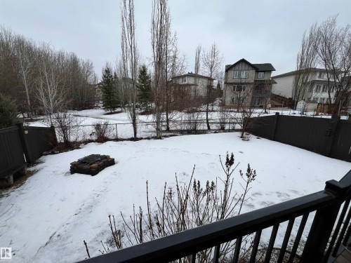 The property features a fenced yard, a fire pit, and views of surrounding trees and properties - 21917 95A Avenue, Edmonton, AB - Outdoor