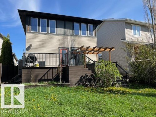 Rear exterior featuring a multi-level composite deck with a wood pergola - 21917 95A Avenue, Edmonton, AB - Outdoor With Exterior