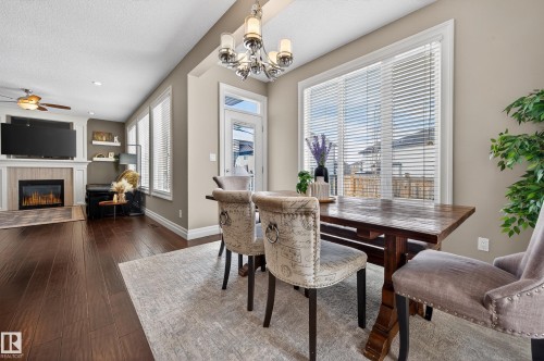 5204 Rue Eaglemont, Beaumont, AB - Indoor Photo Showing Dining Room With Fireplace