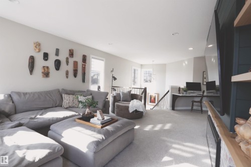 Spacious living area featuring light-colored walls, recessed lighting, and carpeted flooring throughout - 1003 Huckell Place, Edmonton, AB - Indoor Photo Showing Living Room