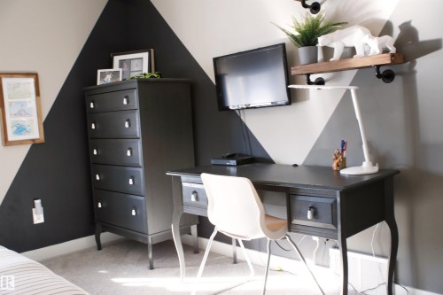 This room features distinct geometric wall patterns, carpeted floors, and a wall-mounted shelf - 1003 Huckell Place, Edmonton, AB - Indoor