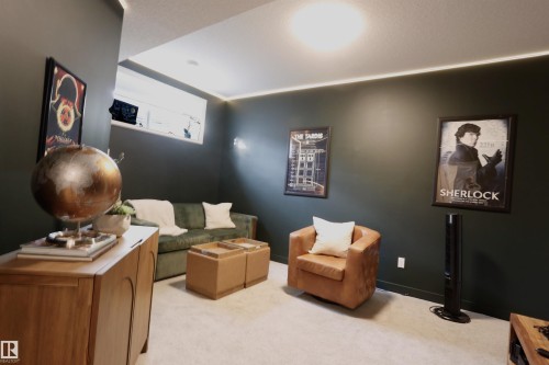 This room features dark-painted walls, a light-colored carpet, and a window providing natural light - 1003 Huckell Place, Edmonton, AB - Indoor
