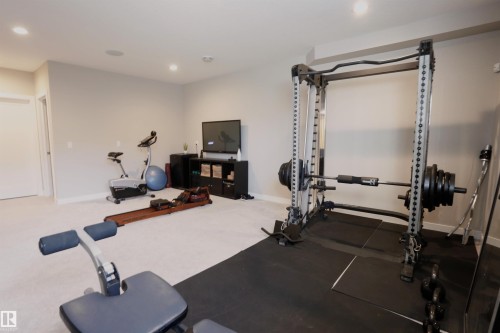 Well-appointed exercise room featuring recessed lighting, light-colored carpeting, a dedicated rubber floor section, and neutral wall paint - 1003 Huckell Place, Edmonton, AB - Indoor Photo Showing Gym Room