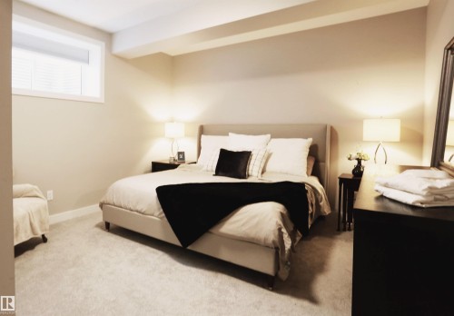 This inviting room features neutral-toned walls, plush carpeting, and a window with blinds providing natural light - 1003 Huckell Place, Edmonton, AB - Indoor Photo Showing Bedroom