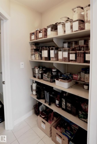 The property features a pantry with extensive built-in shelving, providing ample storage space - 1003 Huckell Place, Edmonton, AB - Indoor