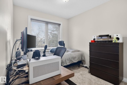 This room features a window with blinds, light-colored walls, and a textured ceiling - 10418 69 Avenue, Edmonton, AB - Indoor Photo Showing Office