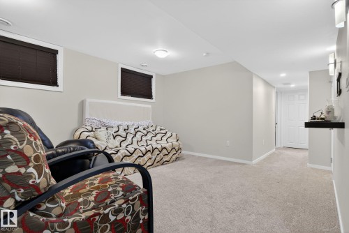 Spacious room featuring light-colored carpeted flooring, light grey walls, and recessed lighting - 10418 69 Avenue, Edmonton, AB - Indoor Photo Showing Other Room