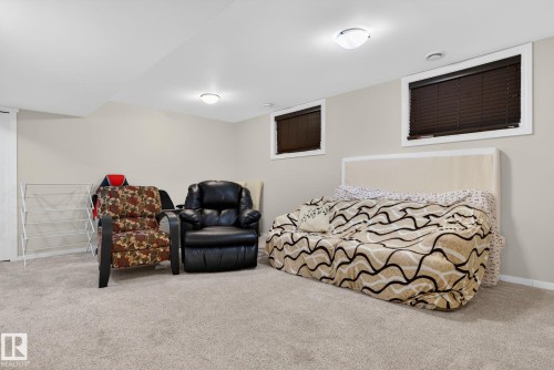 This room features light-colored carpeting, two windows with blinds, and recessed lighting fixtures - 10418 69 Avenue, Edmonton, AB - Indoor Photo Showing Other Room