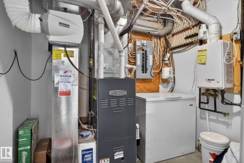 The property includes a water heater, a furnace, and an electrical panel - 10418 69 Avenue, Edmonton, AB - Indoor Photo Showing Basement