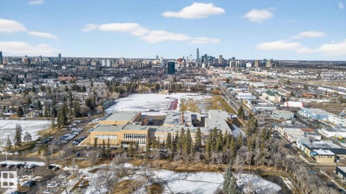 Aerial view showcasing the property's surrounding neighborhood, featuring a cityscape with numerous buildings in the distance - 10418 69 Avenue, Edmonton, AB - Outdoor With View