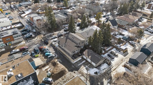 The property is situated in a neighborhood featuring various architectural styles and mature trees - 10418 69 Avenue, Edmonton, AB - Outdoor With View