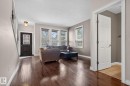 The property features hardwood flooring throughout the main living area, complemented by neutral wall tones - 10418 69 Avenue, Edmonton, AB  - Indoor Photo Showing Living Room 