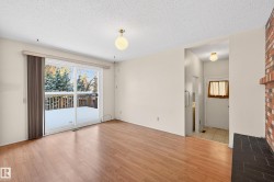 Empty room featuring a textured ceiling, plenty of natural light, and light wood finished floors - 