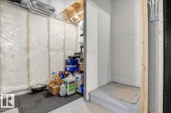 The property features an unfinished basement area with visible insulation, exposed wooden framing, and overhead ductwork - 