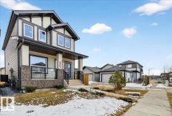 The property features a two-story elevation with a pitched roof and a covered porch - 