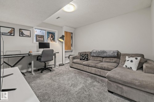 The property features a spacious room with light gray carpeting, neutral white walls, and a recessed window - 9321 92 Street, Edmonton, AB - Indoor