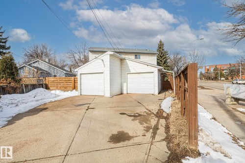 The property features a detached two-car garage with white garage doors and white siding - 9321 92 Street, Edmonton, AB - Outdoor