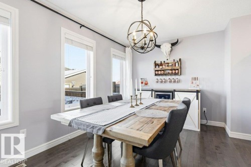 Dining area featuring dark hardwood floors, white baseboards, and light gray walls - 16720 15 Avenue, Edmonton, AB - Indoor Photo Showing Dining Room