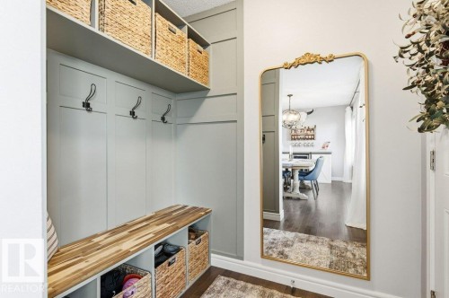Entryway featuring built-in storage with a wooden bench, wall hooks, and overhead shelving - 16720 15 Avenue, Edmonton, AB - Indoor Photo Showing Other Room