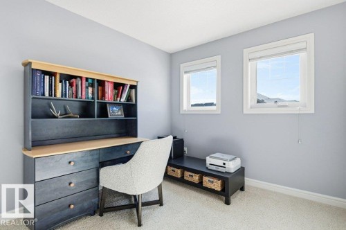 This room features two windows and light-colored carpeting - 16720 15 Avenue, Edmonton, AB - Indoor Photo Showing Office