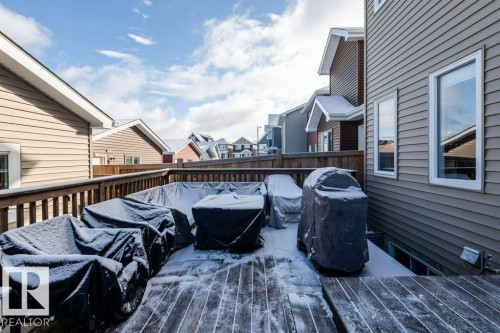 The property features a wooden deck with a wooden privacy fence, providing an inviting outdoor space - 16720 15 Avenue, Edmonton, AB - Outdoor With Deck Patio Veranda With Exterior