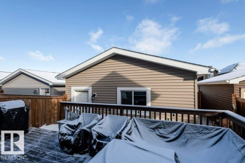 The property features an exterior with beige horizontal siding and a white trim - 16720 15 Avenue, Edmonton, AB - Outdoor With Deck Patio Veranda With Exterior