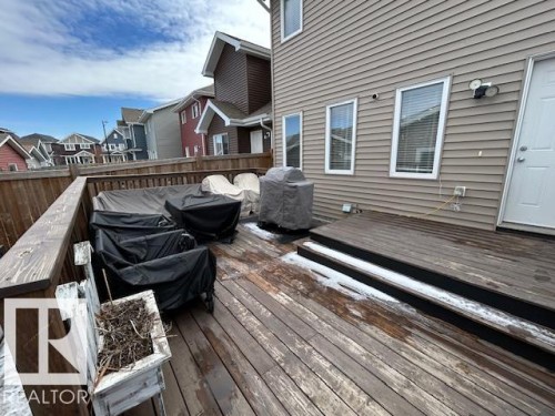 Expansive wooden deck with railing, providing outdoor living space - 16720 15 Avenue, Edmonton, AB - Outdoor With Deck Patio Veranda With Exterior